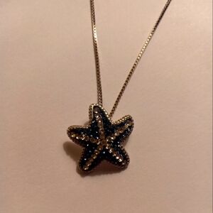 Silver starfish necklace with silver and blue rhinestones.